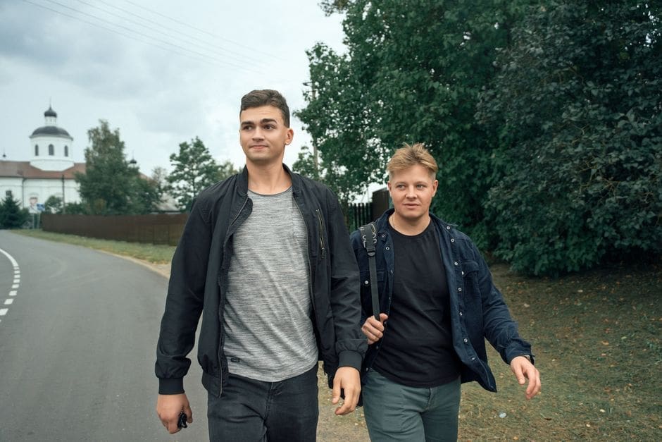 Group of men walking together on a tree-lined path in the Treasure Valley