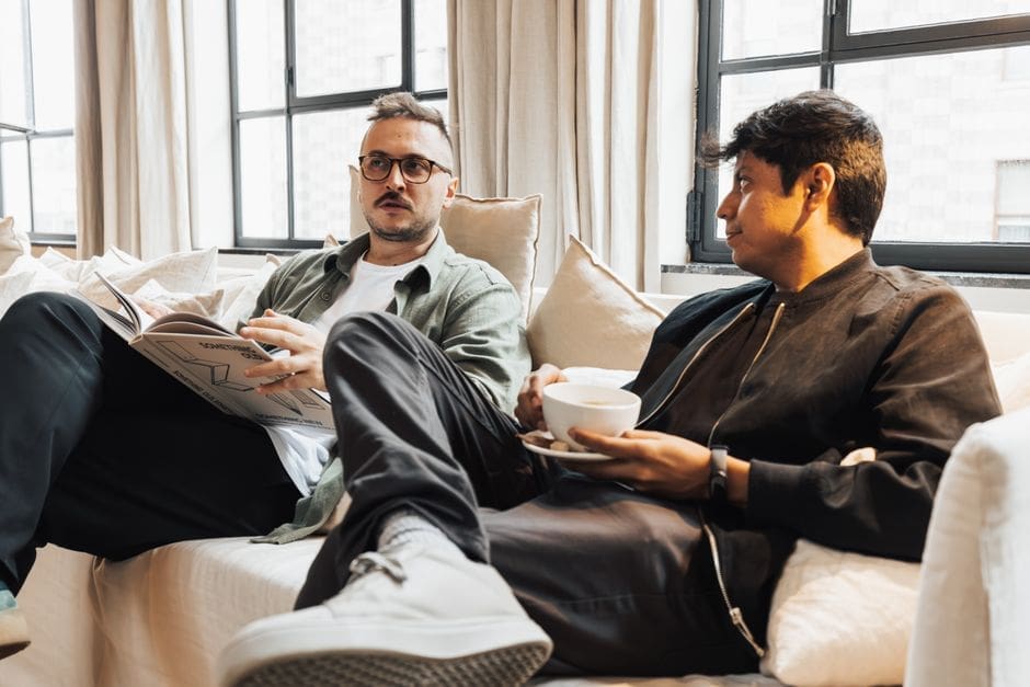 Two men having a focused conversation over coffee at a table